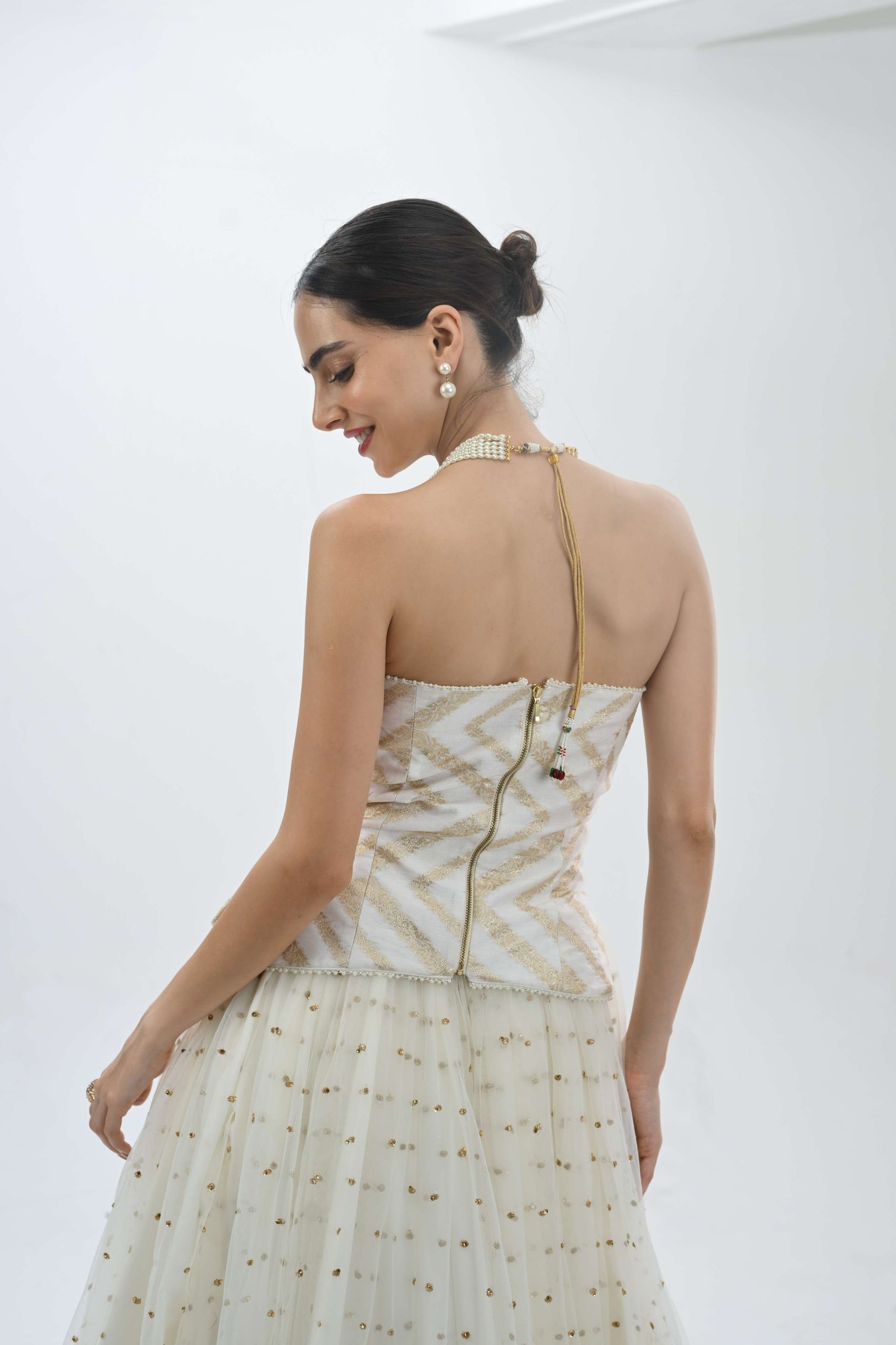 Off shoulder bustier princess lehenga in off-white by Label N