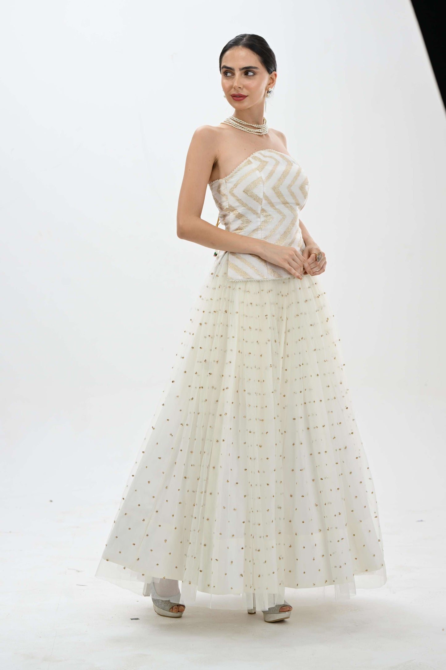 Off shoulder bustier princess lehenga in off-white by Label N