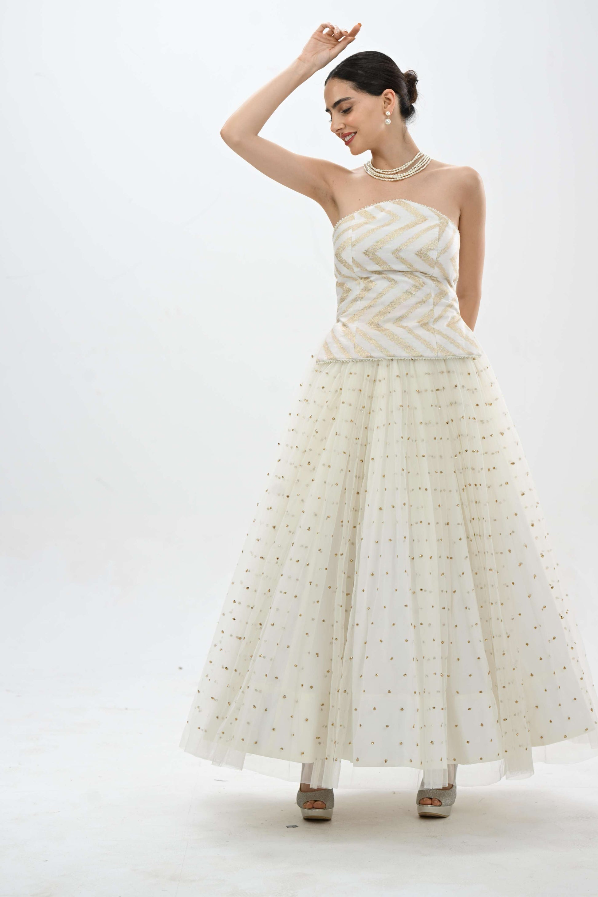 Off shoulder bustier princess lehenga in off-white by Label N