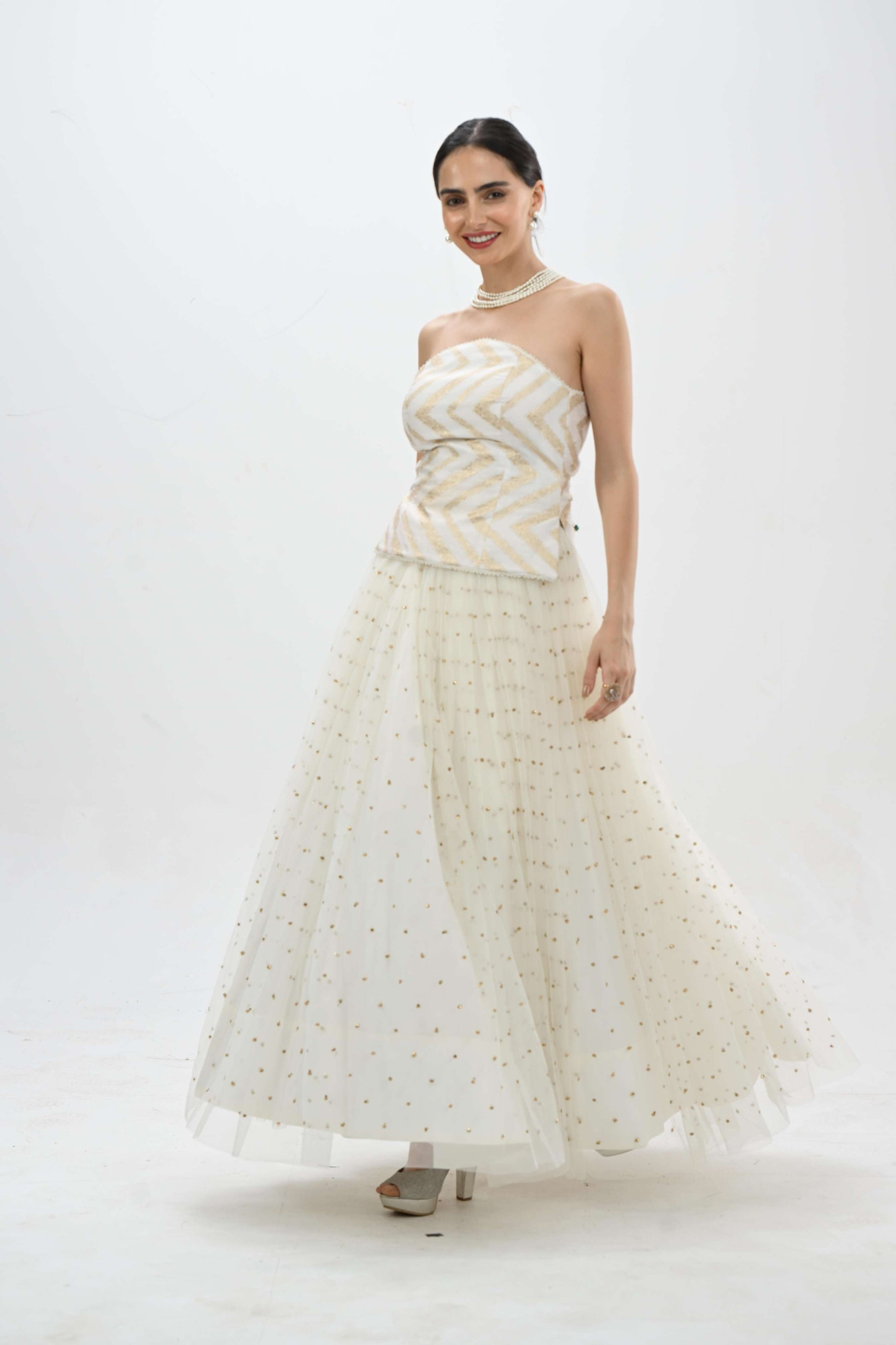 Off shoulder bustier princess lehenga in off-white by Label N